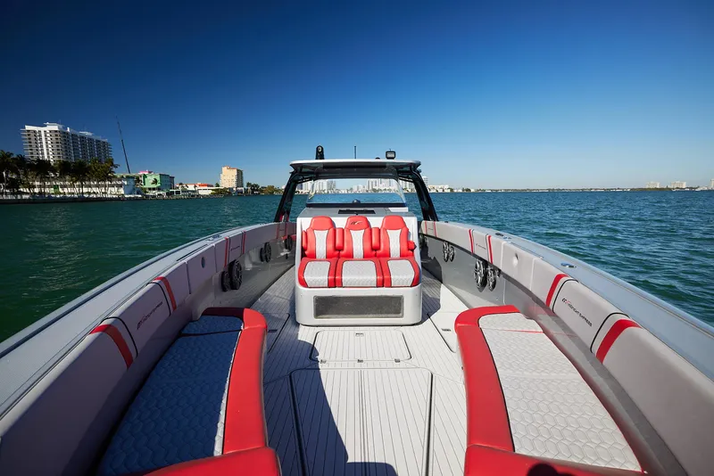 Slide: The Image of 2017 Midnight Express 43' Open boat with red and white seating on calm water. - 6