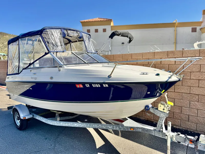 Slide: The Image of 2007 Bayliner 192 Cuddy Discovery boat on trailer, parked outdoors. - 1
