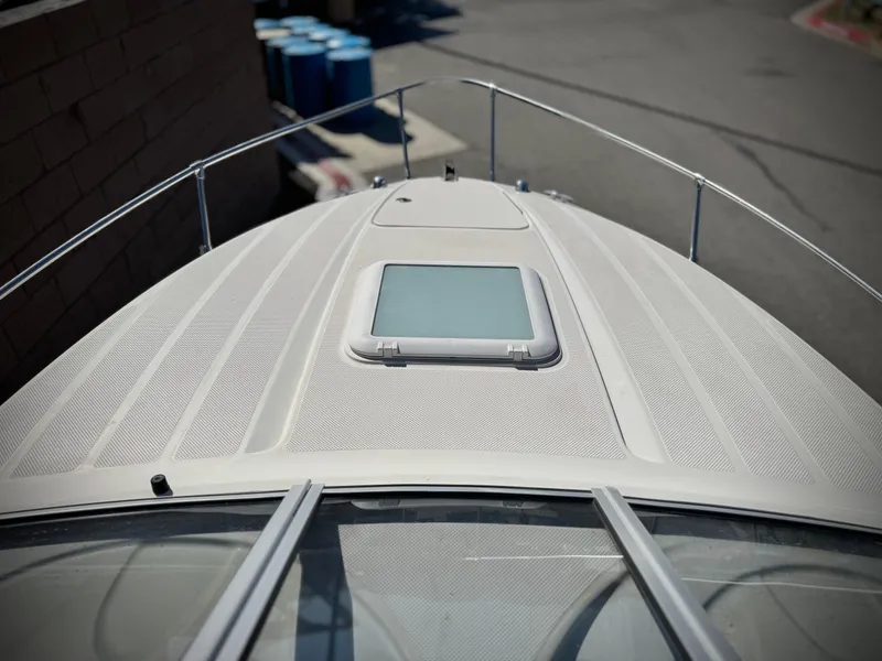 Slide: The Image of 2007 Bayliner 192 Cuddy Discovery boat deck with hatch, docked outdoors. - 10