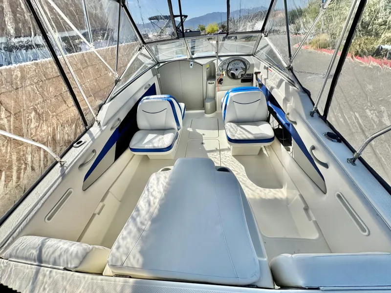 Slide: The Image of 2007 Bayliner 192 Cuddy Discovery boat interior with seating and steering wheel. - 12