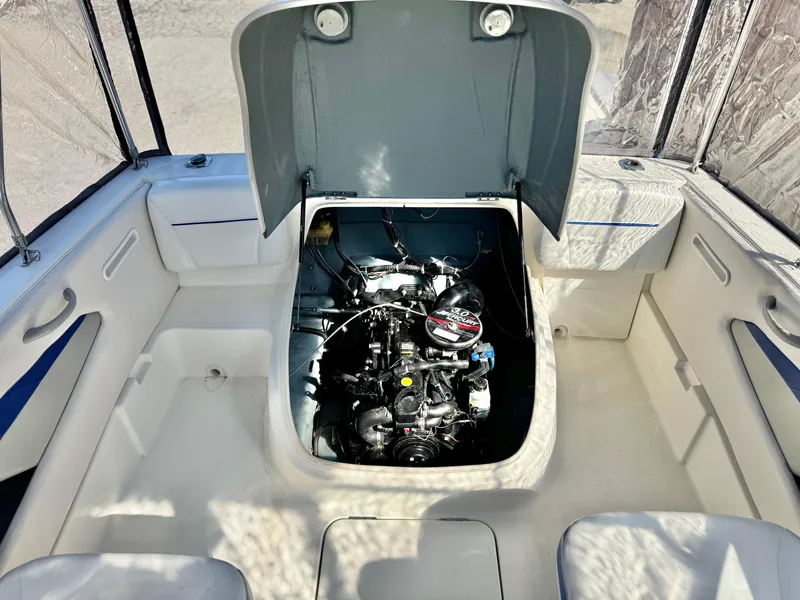 Slide: The Image of 2007 Bayliner 192 Cuddy Discovery boat engine compartment with open hatch. - 14