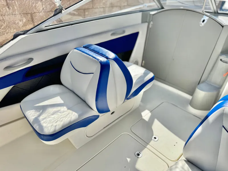 Slide: The Image of 2007 Bayliner 192 Cuddy Discovery interior with white and blue seating. - 17