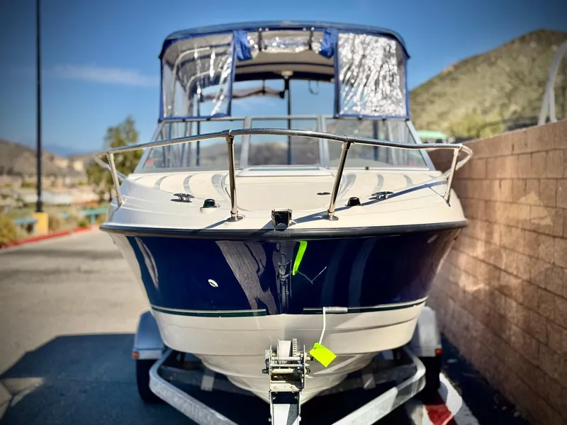 Slide: The Image of 2007 Bayliner 192 Cuddy Discovery boat on trailer, parked outdoors. - 2