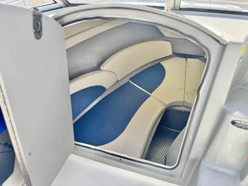 Slide: The Image of 2007 Bayliner 192 Cuddy Discovery cabin interior with blue and white seating. - 23