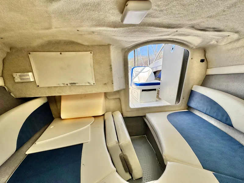 Slide: The Image of Interior of 2007 Bayliner 192 Cuddy Discovery boat, featuring cozy seating and compact design. - 25