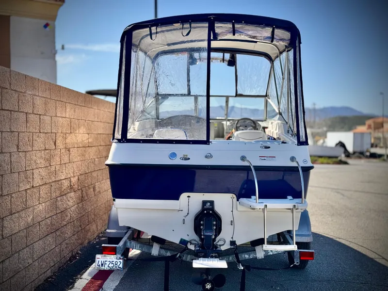 Slide: The Image of 2007 Bayliner 192 Cuddy Discovery boat, rear view, parked on a sunny day. - 4
