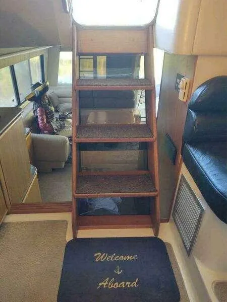 Slide: The Image of Interior of 2000 Bayliner 4788 Pilot House Motoryacht with stairs and welcome mat. - 10