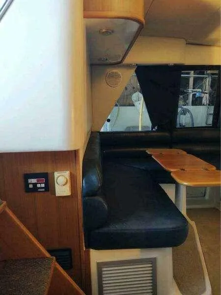 Slide: The Image of Interior of 2000 Bayliner 4788 Pilot House Motoryacht with seating and table. - 11