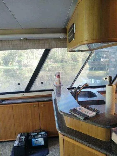 Slide: The Image of Interior of 2000 Bayliner 4788 Pilot House Motoryacht with kitchen and scenic window view. - 12