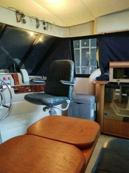 Slide: The Image of Interior of 2000 Bayliner 4788 Pilot House Motoryacht with captain's chair and control panel. - 13