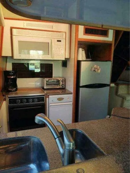 Slide: The Image of 2000 Bayliner 4788 Pilot House Motoryacht kitchen with appliances and dual sink. - 14