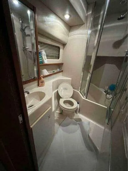 Slide: The Image of Bathroom interior of 2000 Bayliner 4788 Pilot House Motoryacht, featuring toilet and shower. - 15