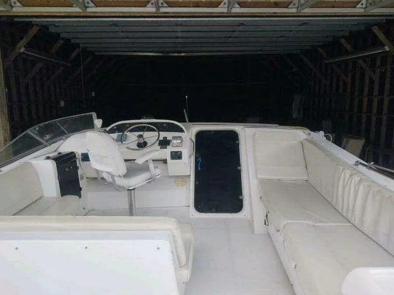 Slide: The Image of 2000 Bayliner 4788 Pilot House Motoryacht interior with white seating and steering area. - 6