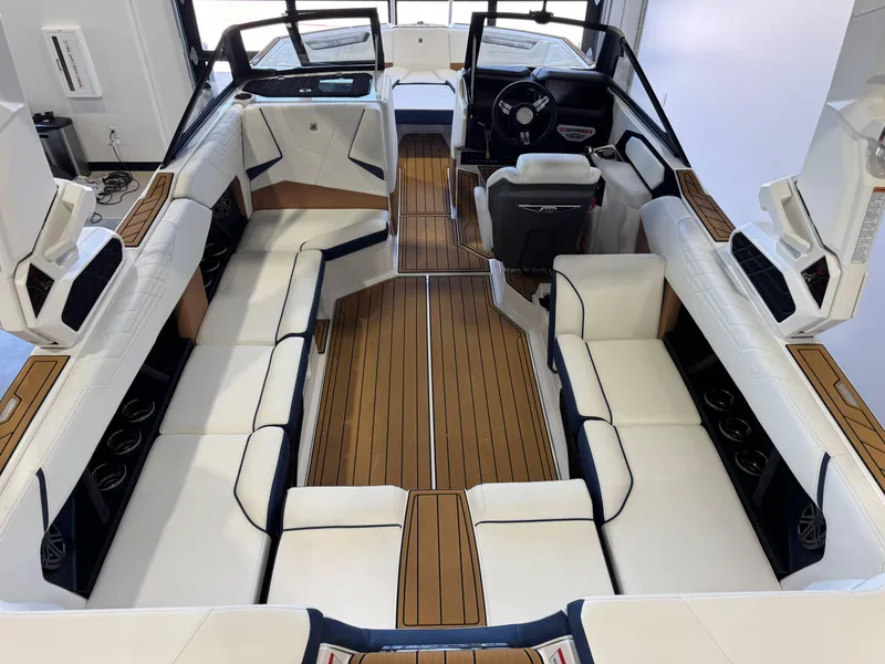 Slide: The Image of Interior of 2025 Nautique Super Air Nautique S23, featuring luxurious seating and sleek design. - 12