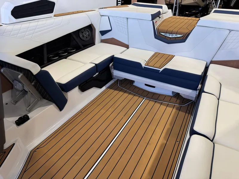 Slide: The Image of 2025 Nautique Super Air Nautique S23 interior with luxurious seating and teak flooring. - 14