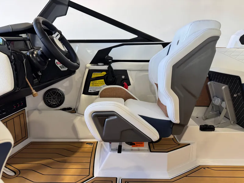 Slide: The Image of 2025 Nautique Super Air Nautique S23 cockpit with modern steering and seating design. - 22
