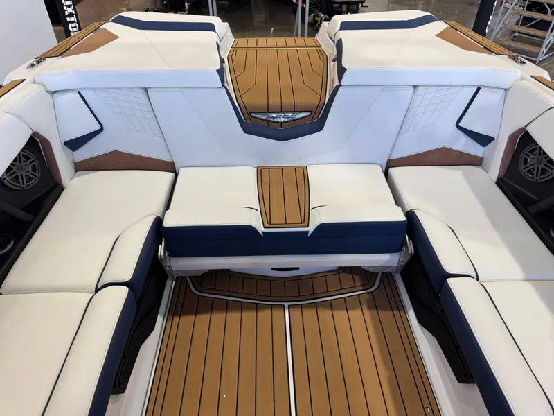 Slide: The Image of 2025 Nautique Super Air Nautique S23 interior with luxurious seating and teak flooring. - 26