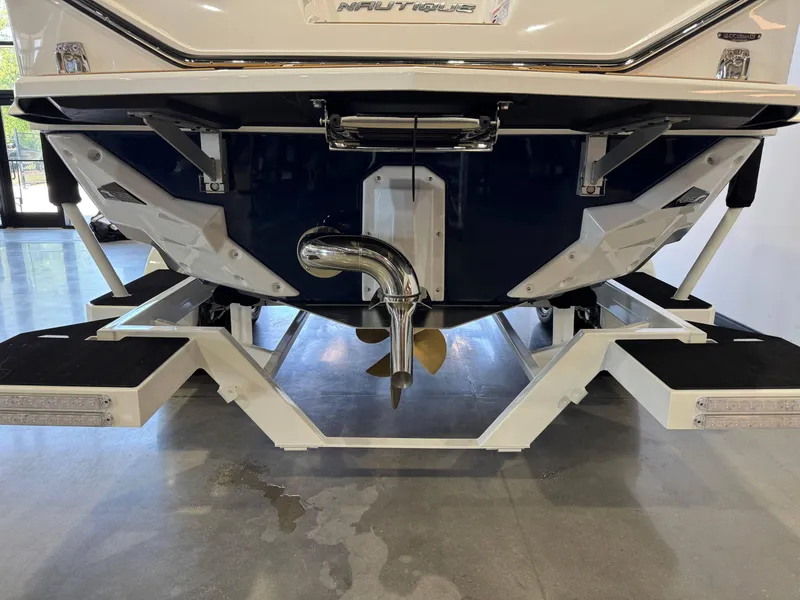 Slide: The Image of 2025 Nautique Super Air Nautique S23 boat stern with propeller and platform. - 6