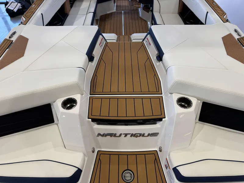 Slide: The Image of 2025 Nautique Super Air Nautique S23 interior with sleek seating and teak flooring. - 9