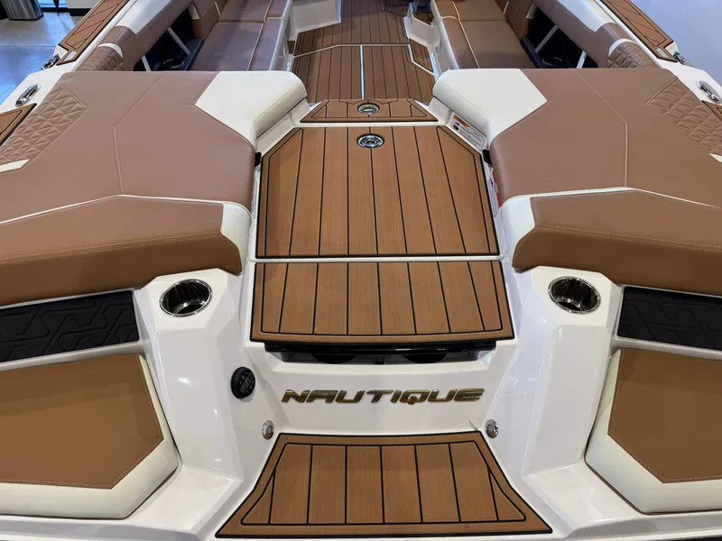 Slide: The Image of 2025 Nautique Super Air Nautique GS24 boat interior with brown and white seating. - 10
