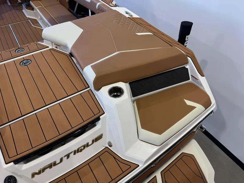 Slide: The Image of 2025 Nautique Super Air Nautique GS24 boat interior with brown and white seating. - 11