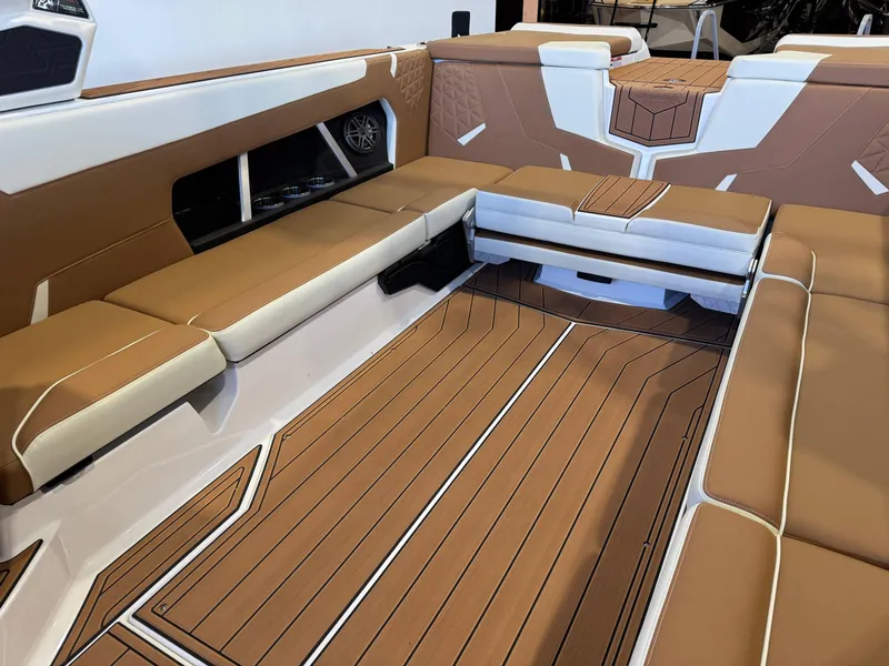 Slide: The Image of Luxurious interior of 2025 Nautique Super Air Nautique GS24 boat with tan seating. - 15