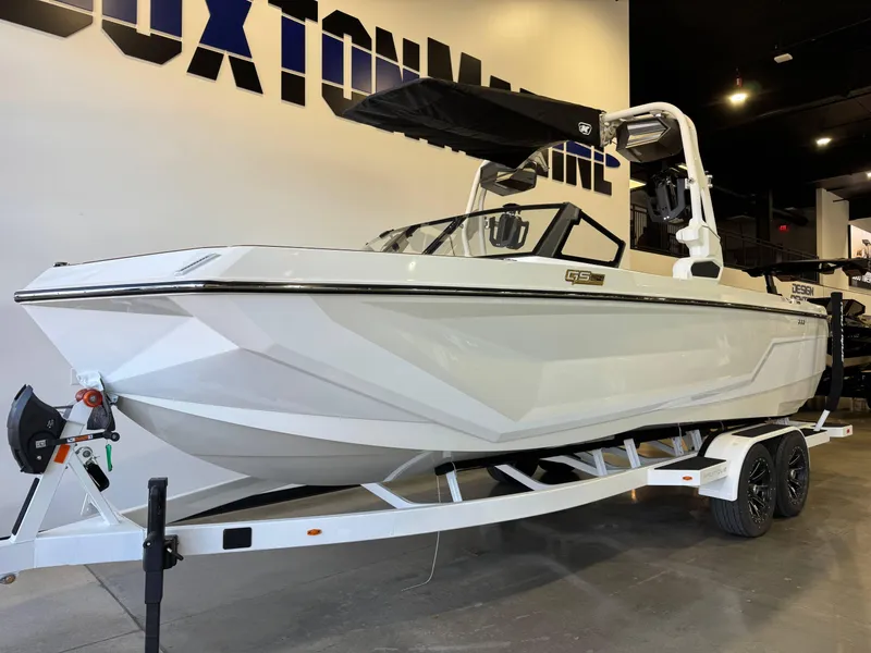 Slide: The Image of 2025 Nautique Super Air Nautique GS24 boat on trailer in showroom. - 2