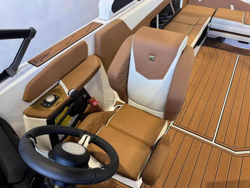 Slide: The Image of 2025 Nautique Super Air Nautique GS24 interior with tan and white seating, sleek design. - 21