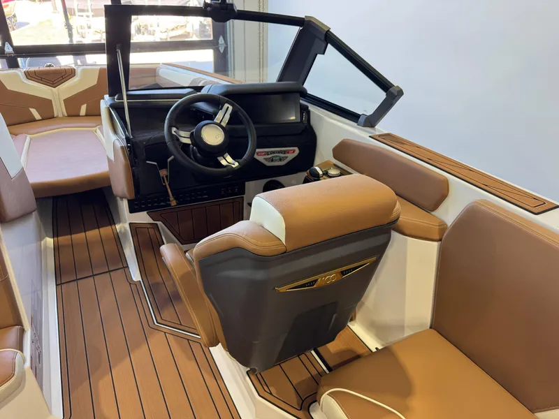 Slide: The Image of 2025 Nautique Super Air Nautique GS24 interior with tan seating and modern dashboard. - 24