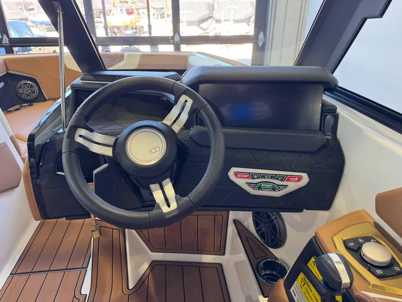 Slide: The Image of 2025 Nautique Super Air Nautique GS24 dashboard with steering wheel and control panel. - 26