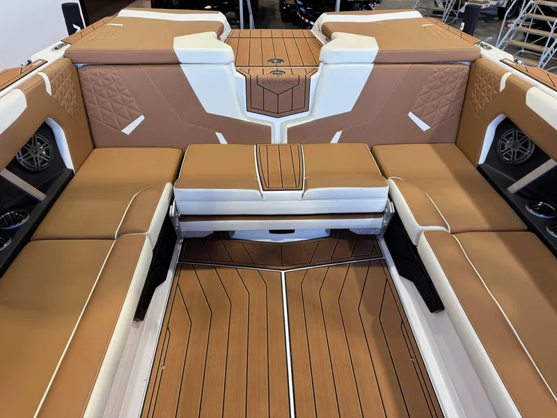 Slide: The Image of 2025 Nautique Super Air Nautique GS24 interior with tan and white seating, luxury design. - 27