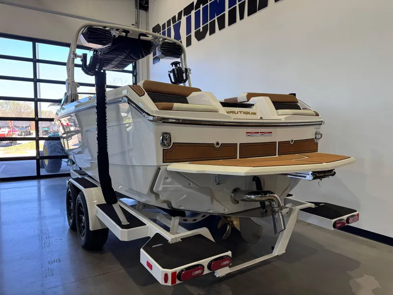 Slide: The Image of 2025 Nautique Super Air Nautique GS24 boat on trailer in showroom. - 5