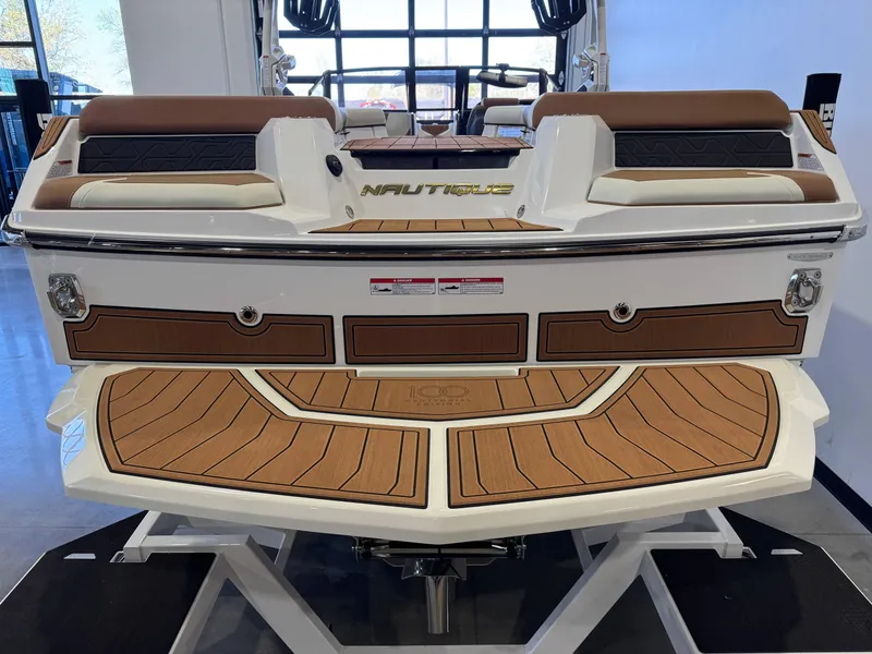 Slide: The Image of 2025 Nautique Super Air Nautique GS24 boat rear view with teak deck and seating. - 8