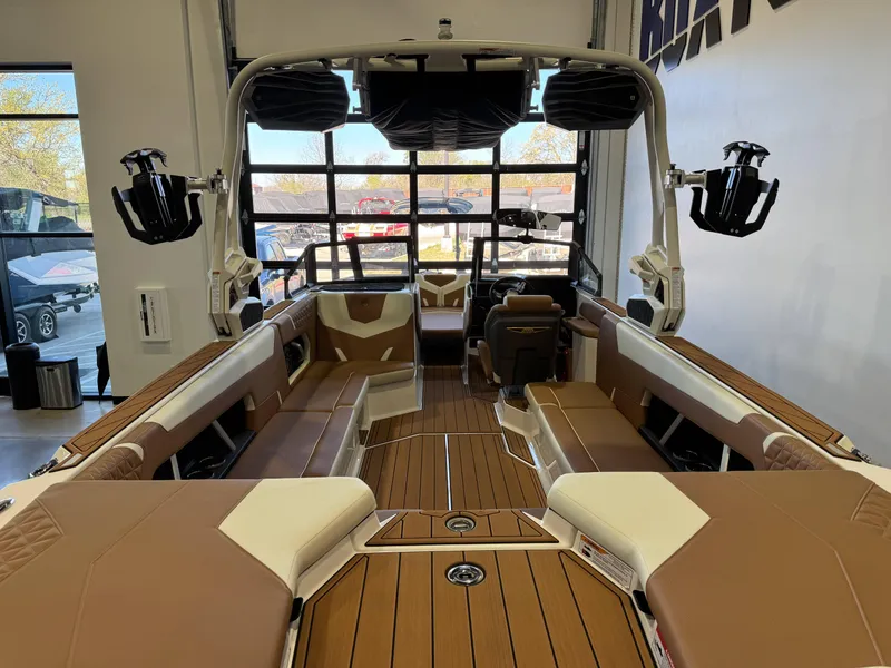 Slide: The Image of 2025 Nautique Super Air Nautique GS24 interior with brown and white seating, showcasing luxury design. - 9