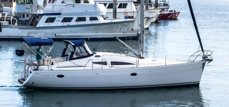 Slide: The Image of 2011 Elan Impression 384 sailboat docked in a marina, surrounded by other vessels. - 0