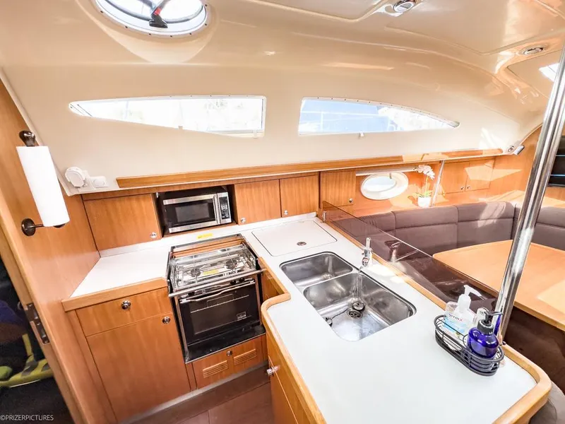 Slide: The Image of Interior of 2011 Elan Impression 384 yacht with modern kitchen and seating area. - 1