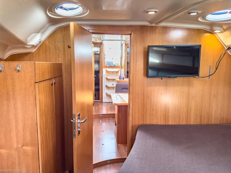Slide: The Image of Interior of 2011 Elan Impression 384 yacht with wood paneling and mounted TV. - 15