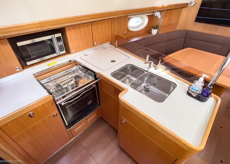 Slide: The Image of Modern kitchen in 2011 Elan Impression 384 yacht with stove, sink, and dining area. - 19