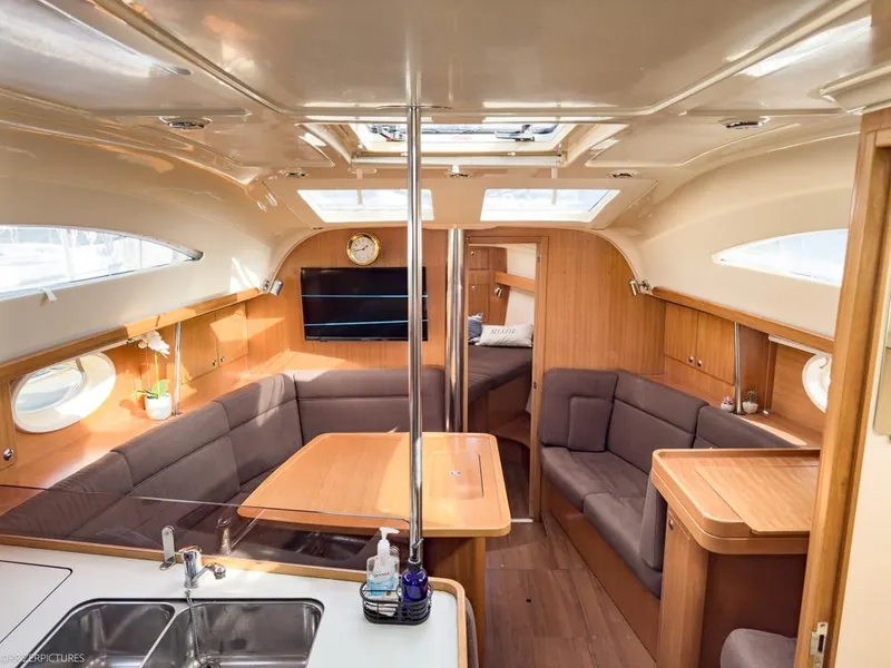 Slide: The Image of Interior of 2011 Elan Impression 384 yacht with cozy seating and wooden finishes. - 2