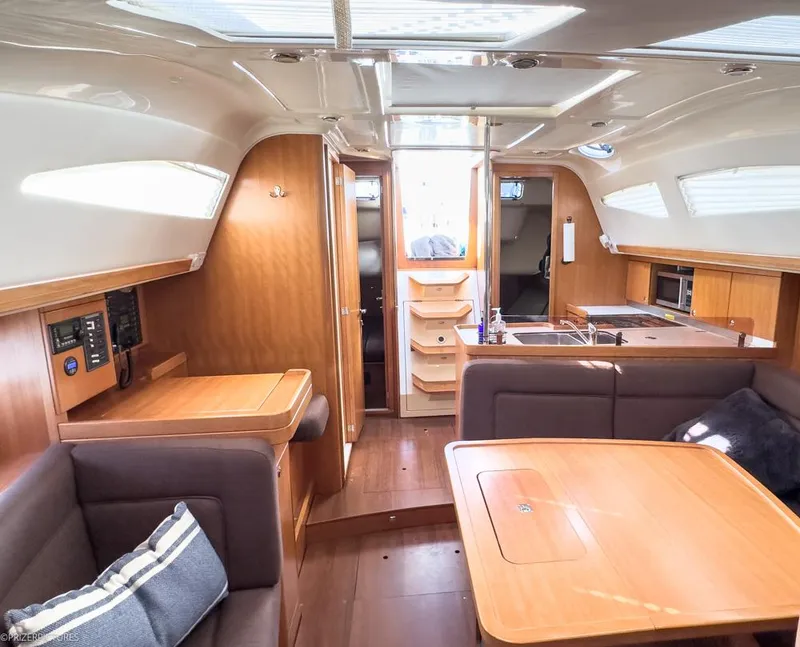 Slide: The Image of Interior of 2011 Elan Impression 384 yacht, featuring cozy seating and wooden finishes. - 20