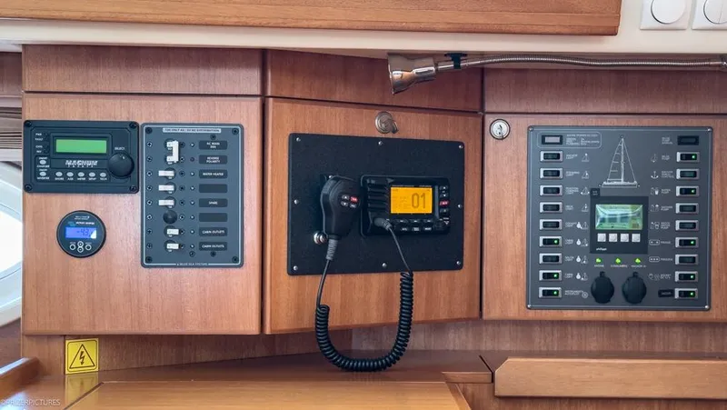 Slide: The Image of Control panel of a 2011 Elan Impression 384 yacht, featuring navigation and communication equipment. - 24