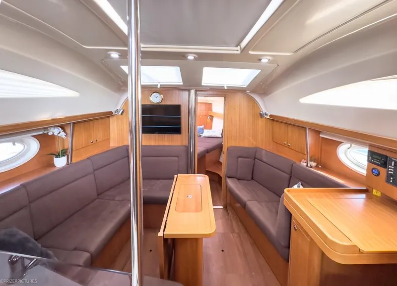 Slide: The Image of Interior of 2011 Elan Impression 384 yacht, featuring cozy seating and wooden finishes. - 28