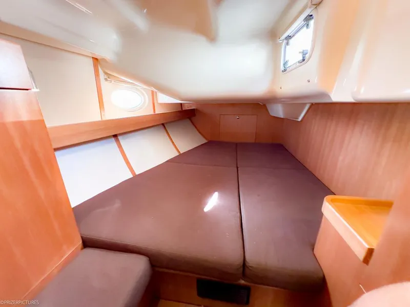 Slide: The Image of Cozy cabin interior of 2011 Elan Impression 384 sailboat with wooden finish and comfortable bedding. - 29