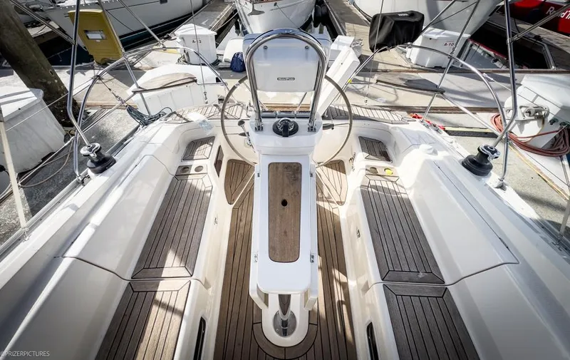 Slide: The Image of Cockpit of 2011 Elan Impression 384 sailboat with dual steering wheels and wooden flooring. - 33