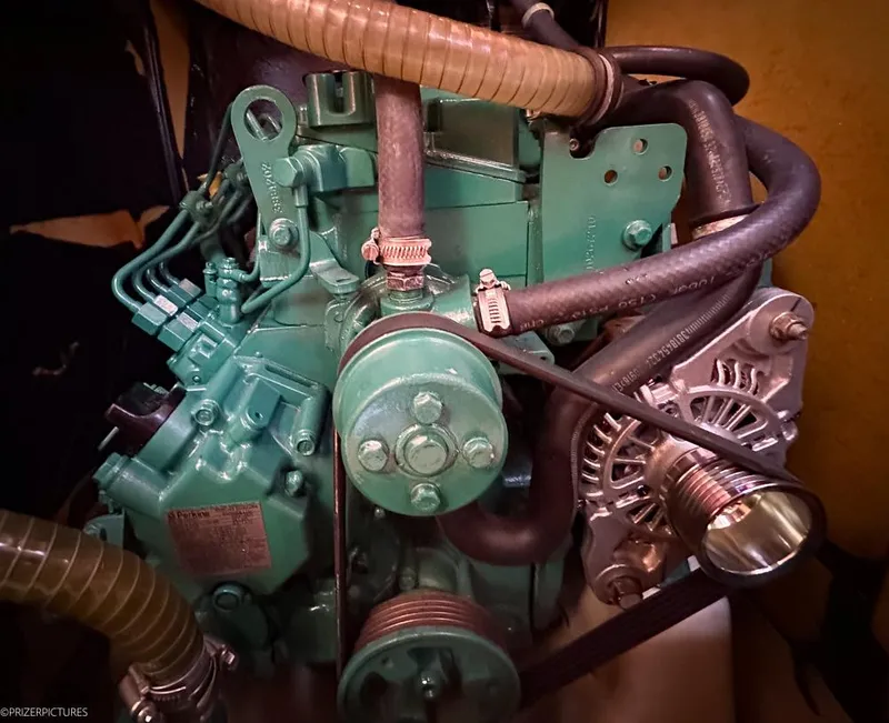 Slide: The Image of Engine compartment of a 2011 Elan Impression 384 sailboat, featuring hoses and mechanical components. - 35