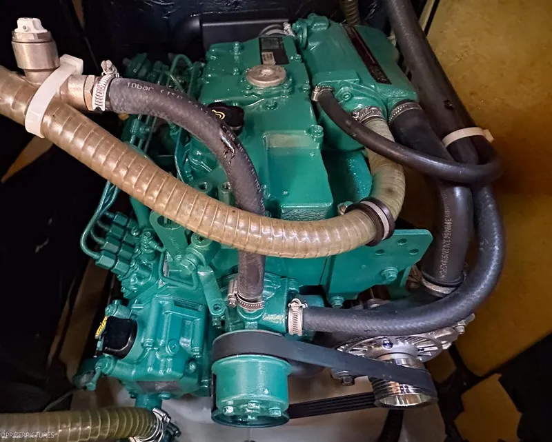 Slide: The Image of Engine of a 2011 Elan Impression 384 sailboat with visible hoses and components. - 36