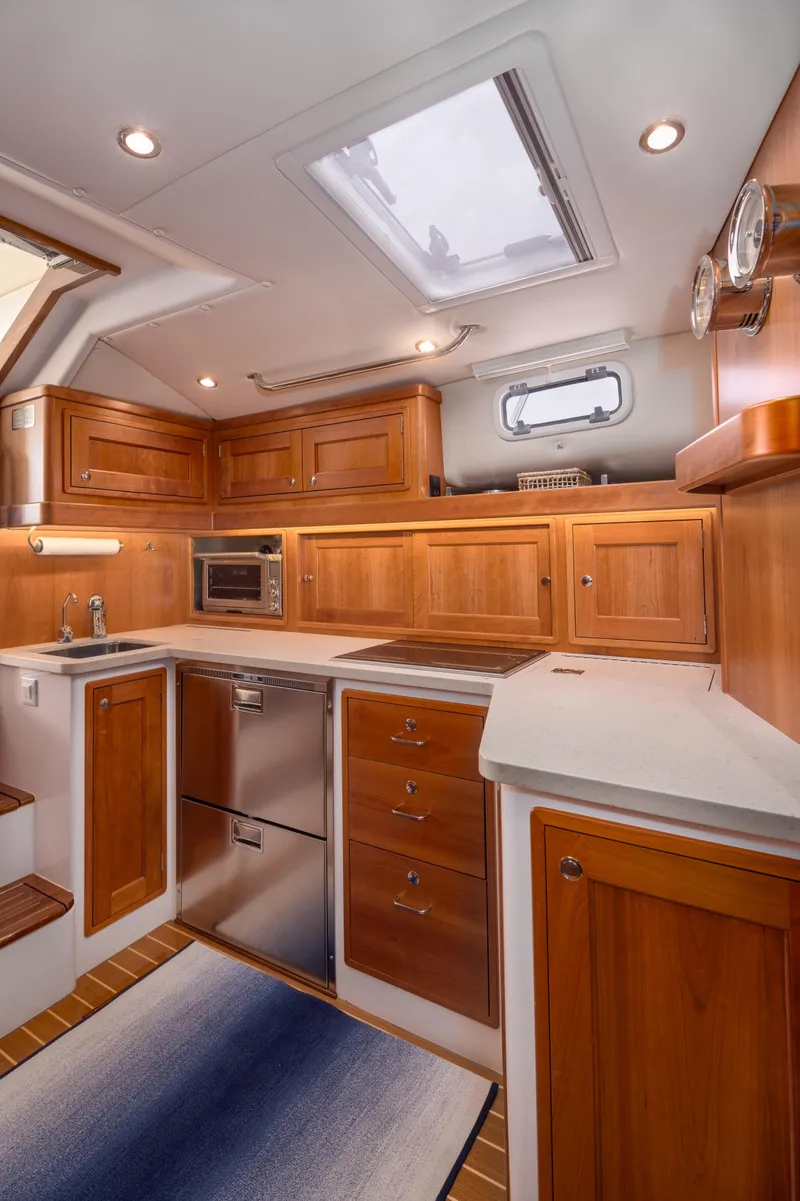 Slide: The Image of Luxurious 2020 MJM 53z yacht kitchen with wooden cabinetry and modern appliances. - 13
