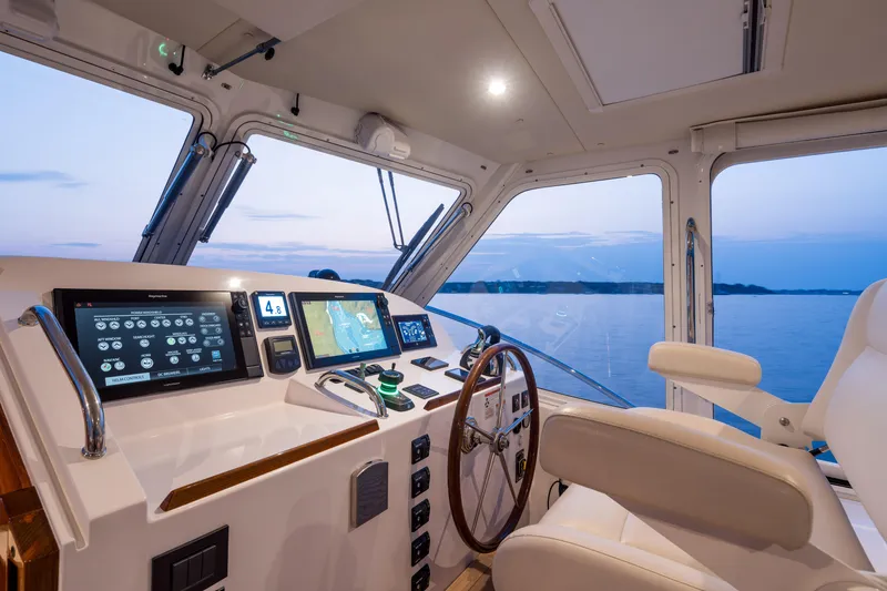 Slide: The Image of Helm of 2020 MJM 53z yacht with advanced navigation systems at sunset. - 2