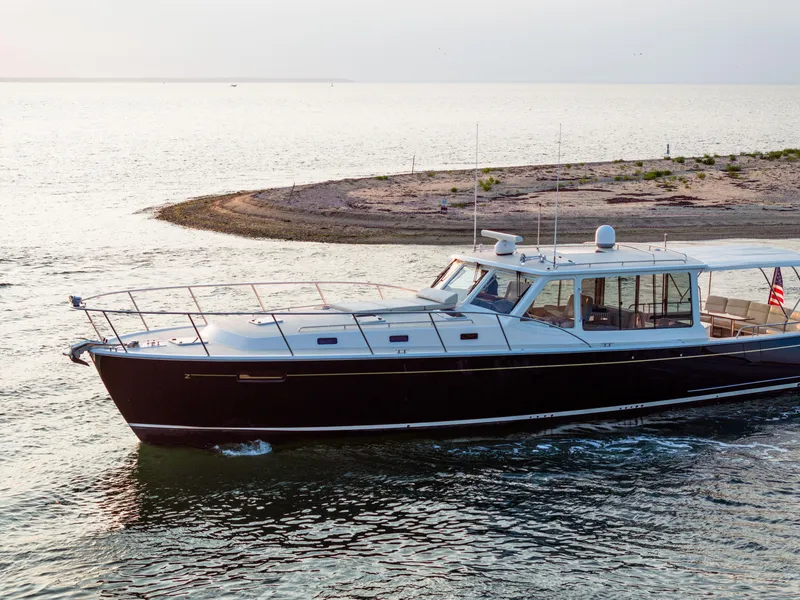 Slide: The Image of Luxury MJM 53z yacht cruising near a small island at sunset, 2020 model. - 3