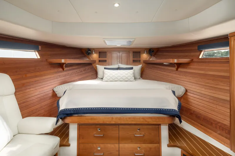 Slide: The Image of Luxurious cabin interior of 2020 MJM 53z yacht with wooden paneling and cozy bedding. - 4